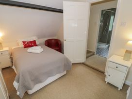A bedroom with a bed and adjoining bathroom at Hillside Cottage