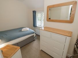 A bedroom with a bed and furniture at Hillside Cottage