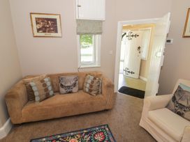 A living room with a sofa and window at Boxbush Lodge in Monmouth