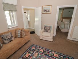 A living room with a sofa and chair at Boxbush Lodge in Monmouth