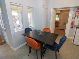 A dining room with a table and chairs at Boxbush Lodge in Monmouth