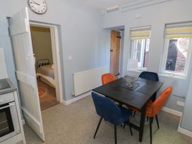 A kitchen with a dining table and chairs at Boxbush Lodge in Monmouth