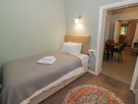 A bedroom with a single bed and an adjacent living area at Boxbush Lodge Monmouth