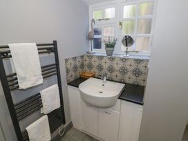 A bathroom with a sink and towels on a towel rail at Boxbush Lodge in Monmouth
