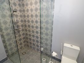 A bathroom with a shower and a toilet at Boxbush Lodge in Monmouth