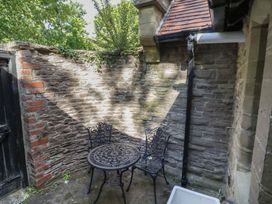 An outdoor seating area with a table and chairs at Boxbush Lodge Monmouth