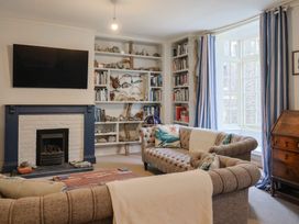 A living room with a television and bookshelf at 5B Bridge Street in Lyme Regis