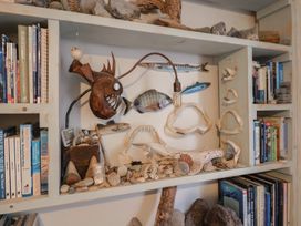A shelf with books and decorative items at 5B Bridge Street Lyme Regis