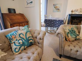 A living room with sofas and a dining table at 5B Bridge Street in Lyme Regis