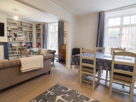 A living room with a sofa and dining table at 5B Bridge Street in Lyme Regis