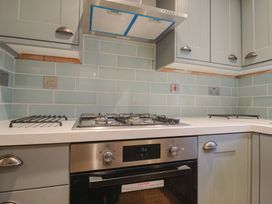 A kitchen with a gas stove and oven at 5B Bridge Street in Lyme Regis