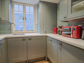 A kitchen with cabinets and appliances at 5B Bridge Street Lyme Regis