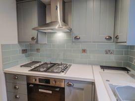 A kitchen with a gas hob and ventilation hood at 5B Bridge Street in Lyme Regis