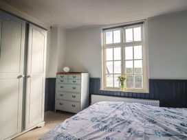 A bedroom with a wardrobe and dresser at 5B Bridge Street in Lyme Regis