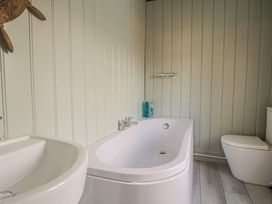 A bathroom with a bathtub and a sink at 5B Bridge Street Lyme Regis