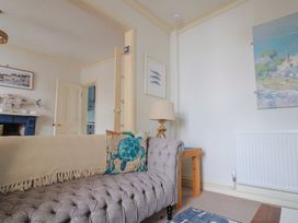 A living room with a sofa and lamp at 5B Bridge Street in Lyme Regis