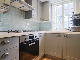 A kitchen with stove, oven, sink and window at 5B Bridge Street Lyme Regis