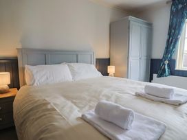 A bedroom with a bed and a wardrobe at 5B Bridge Street Lyme Regis