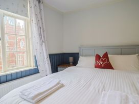 A bedroom with a bed and window at 5B Bridge Street Lyme Regis
