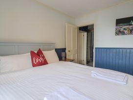 A bedroom with a bed and pillows at 5B Bridge Street Lyme Regis