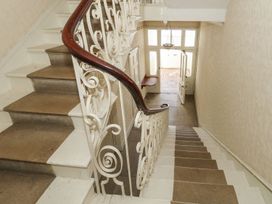 A staircase leading to a front door at 123 On The Sea - The Cubby in Weymouth