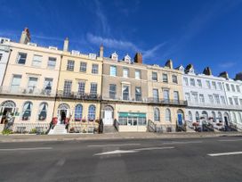 A row of buildings with balconies and windows in Weymouth