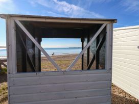 A view through a hut towards the beach and sea at 123 On The Sea - The Cubby, Weymouth
