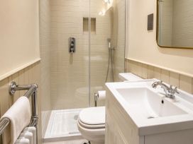 A bathroom featuring a shower, toilet, and sink at 123 On The Sea - The Cubby Weymouth