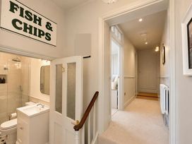 A bathroom with shower, toilet, sink and light fixture at 123 On The Sea - The Cubby in Weymouth