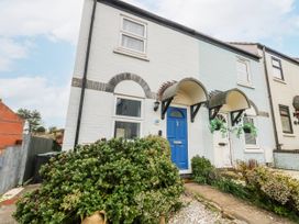A house with a blue front door and pathway at 23 The Maltings in Weymouth