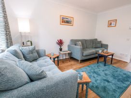 A living room with sofas and a side table at 23 The Maltings in Weymouth