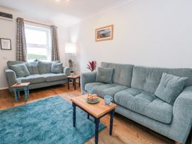 A living room with two sofas and a table at 23 The Maltings in Weymouth