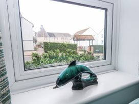 A decorative dolphin sculpture in a window at 23 The Maltings Weymouth