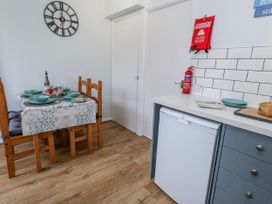 A kitchen with a dining table set for a meal at 23 The Maltings Weymouth