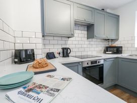 A kitchen with cabinets, oven, microwave, and bread at 23 The Maltings in Weymouth