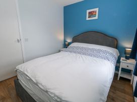 A bedroom with a bed and nightstand at 23 The Maltings in Weymouth
