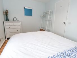 A bedroom with a bed and a chest of drawers at 23 The Maltings in Weymouth