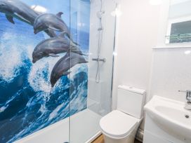 A bathroom with a shower, toilet, and sink at 23 The Maltings in Weymouth