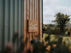 A wooden sign on a tiny house at TWT tiny houses in Carreglefn near Llanfechell