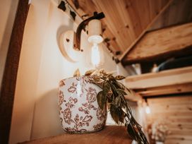 A plant pot and light fixture on a shelf at Rowan in Carreglefn near Llanfechell