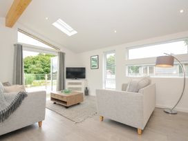 A living room with a sofa and television at 3 Meadow Retreat in Liskeard