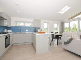 A kitchen with a dining table and chairs at 3 Meadow Retreat Liskeard