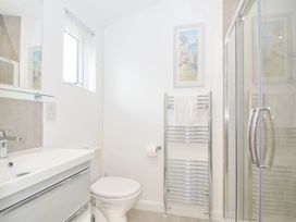 A bathroom with a toilet and shower at 3 Meadow Retreat in Liskeard
