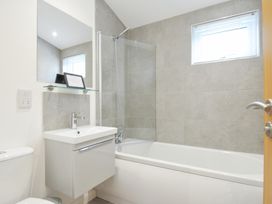 A bathroom with a bathtub and a sink at 3 Meadow Retreat in Liskeard