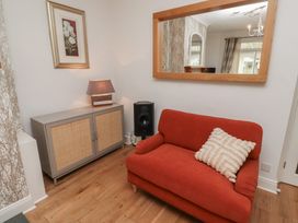 A living room with a sofa and a cabinet at 5 Jackson Terrace Morpeth