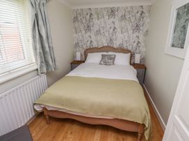 A bedroom with a bed and bedside table at 5 Jackson Terrace in Morpeth