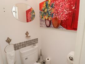 A bathroom with a toilet and artwork at 5 Jackson Terrace in Morpeth