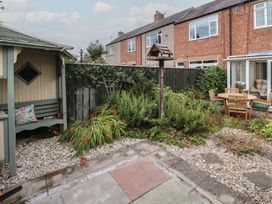 A garden with plants and seating area at 5 Jackson Terrace Morpeth