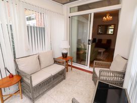 A conservatory with seating and a lamp at Rose Briar Cottage in Morpeth