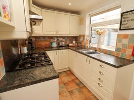 A kitchen with cabinets and a sink at Rose Briar Cottage in Morpeth